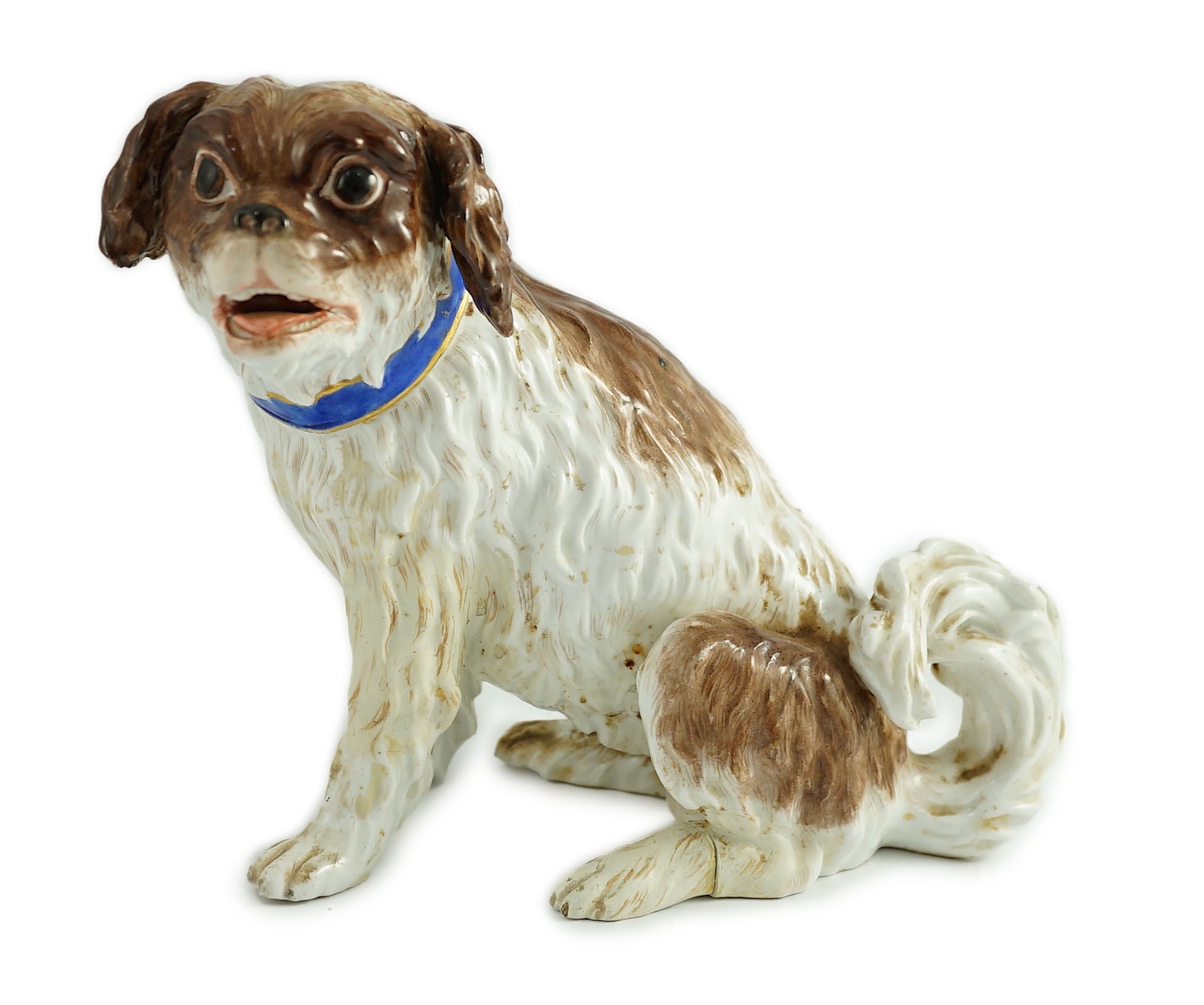A Meissen seated figure of a German Wachtelhund (spaniel), 19th century, 19cm high, restoration and damage